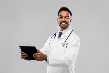 Image showing smiling indian male doctor with tablet computer