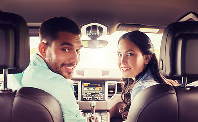 Image showing happy man and woman driving in car