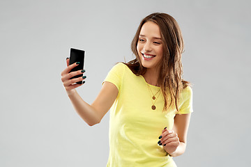 Image showing smiling teenage girl taking selfie by smartphone