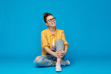 Image showing redhead teenage student girl in glasses dreaming