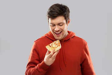 Image showing happy young man eating pizza