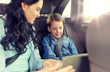 Image showing happy family with tablet pc driving in car