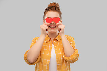 Image showing smiling red haired teenage girl with hearts