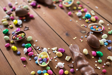 Image showing chocolate eggs and candy drops on wooden table