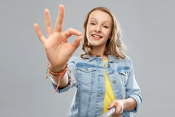 Image showing teenage girl taking picture by selfie stick