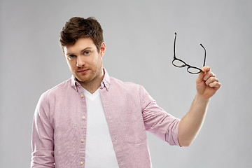 Image showing young man with glasses over grey background