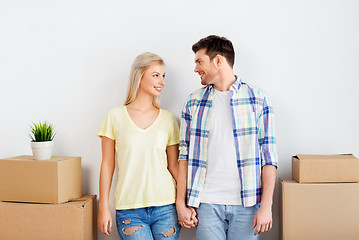 Image showing happy couple with boxes moving to new home