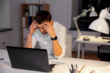 Image showing businessman with papers working at night office