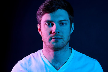 Image showing portrait of man over neon lights in dark room