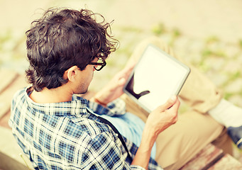 Image showing man with tablet pc sitting on city street bench