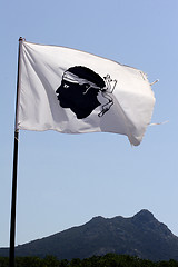 Image showing Corsica flag with mountains in background