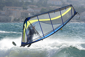 Image showing expert windsurfer in strong wind, surfing his board