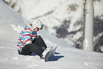 Image showing Snowboarder sitting in the snlow