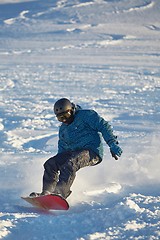 Image showing Snowboarding in fresh powder snow