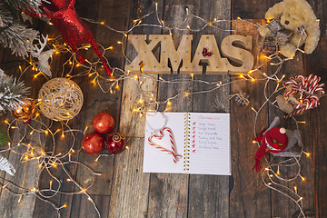 Image showing Christmas List on rustic wood with Christmas decorations