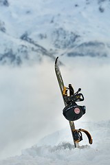 Image showing Snowboard on a mountain top