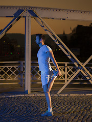 Image showing man jogging across the bridge in the city