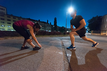 Image showing couple warming up and stretching