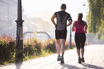 Image showing young couple jogging  in the city