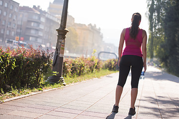 Image showing woman jogging at sunny morning