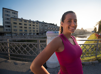 Image showing portrait of a jogging woman at sunny morning