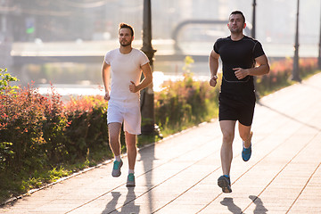 Image showing group of young people jogging in the city