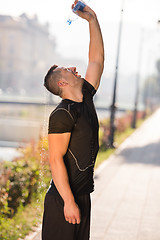 Image showing man pouring water from bottle on his head