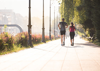 Image showing young couple jogging  in the city