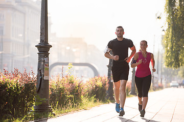 Image showing young couple jogging  in the city