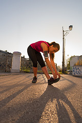 Image showing athlete woman warming up and stretching