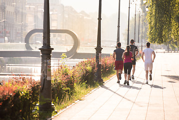 Image showing group of young people jogging in the city