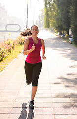 Image showing woman jogging at sunny morning