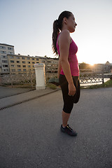 Image showing athlete woman warming up and stretching