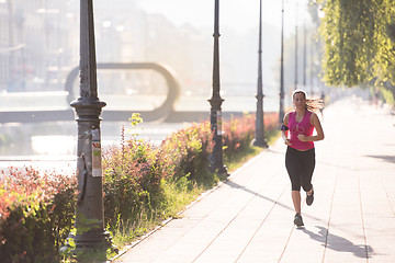 Image showing woman jogging at sunny morning