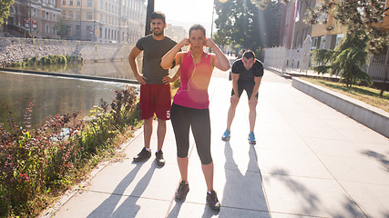 Image showing group of young people jogging in the city