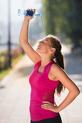 Image showing woman pouring water from bottle on her head