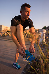 Image showing man tying running shoes laces