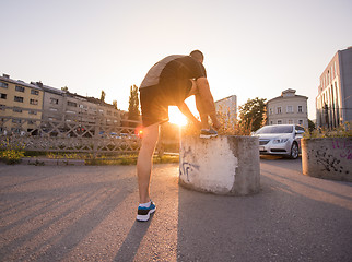 Image showing man tying running shoes laces