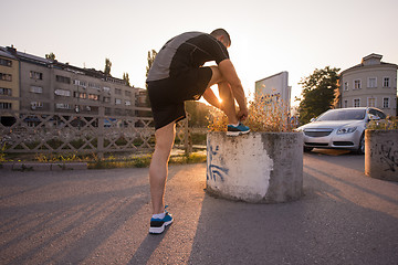 Image showing man tying running shoes laces