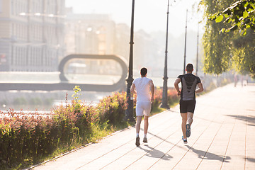 Image showing group of young people jogging in the city