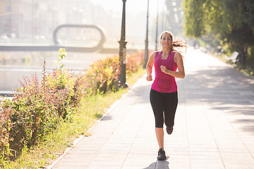 Image showing woman jogging at sunny morning