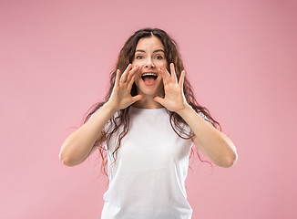 Image showing Isolated on pink young casual woman shouting at studio