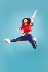 Image showing Freedom in moving. Pretty young woman jumping against pink background