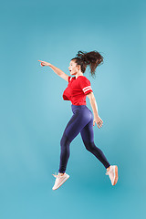 Image showing Freedom in moving. Pretty young woman jumping against pink background