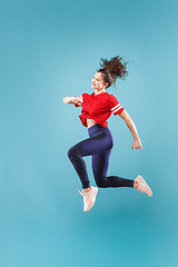 Image showing Freedom in moving. Pretty young woman jumping against pink background