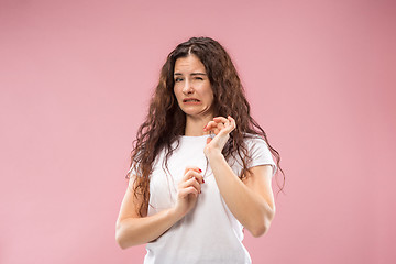 Image showing Young woman with disgusted expression repulsing something, isolated on the pink