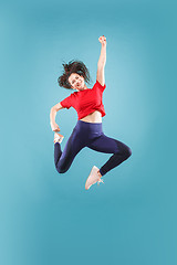 Image showing Freedom in moving. Pretty young woman jumping against pink background