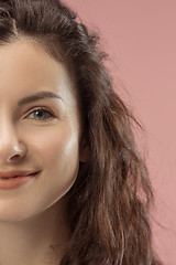 Image showing The happy business woman standing and smiling against pink background.