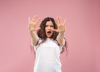 Image showing Portrait of the scared woman on pink