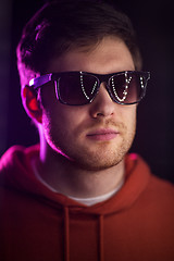 Image showing man in sunglasses over ultra violet neon lights